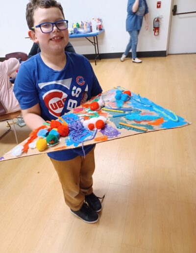 boy showing pizza painting work