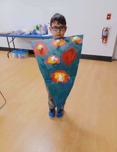 boy showing pizza painting work