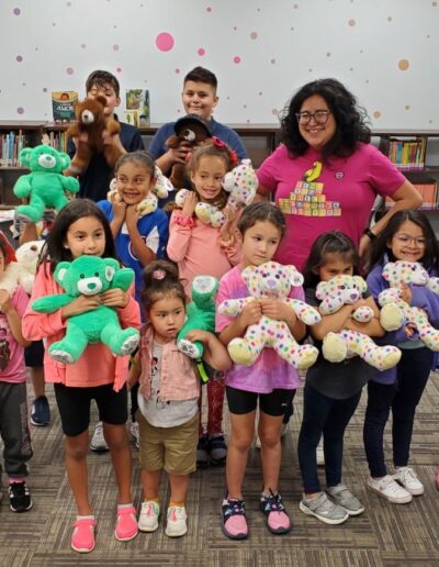 Kids showing a finished work on a Teddy bear program at Hillside Public Library