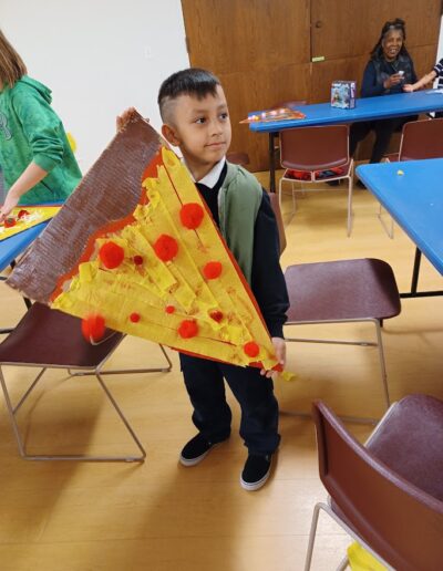 boy showing pizza painting work