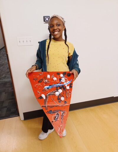 girl showing her pizza painting work